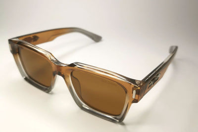 Sunglasses with brown lenses and black frames on a white background