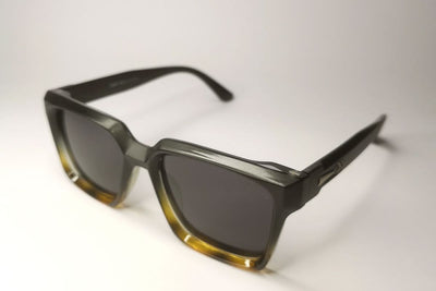 Sunglasses with a gradient design on a light gray background