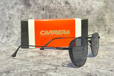 Carrera sunglasses with orange and black box on a gray surface
