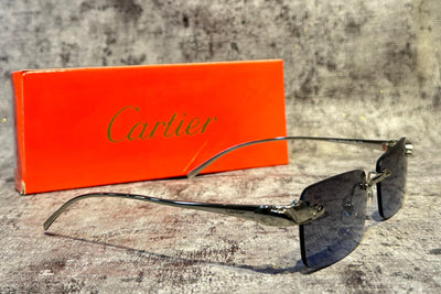 Cartier sunglasses with orange box on a textured surface