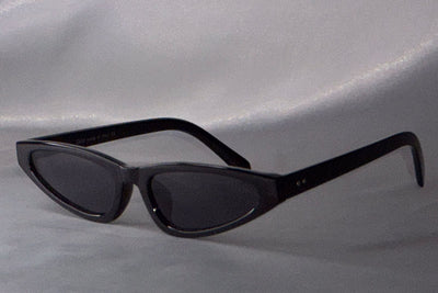 Black sunglasses on a gray background