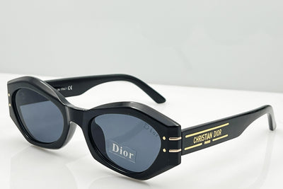 Black Dior sunglasses with gold accents on a white background